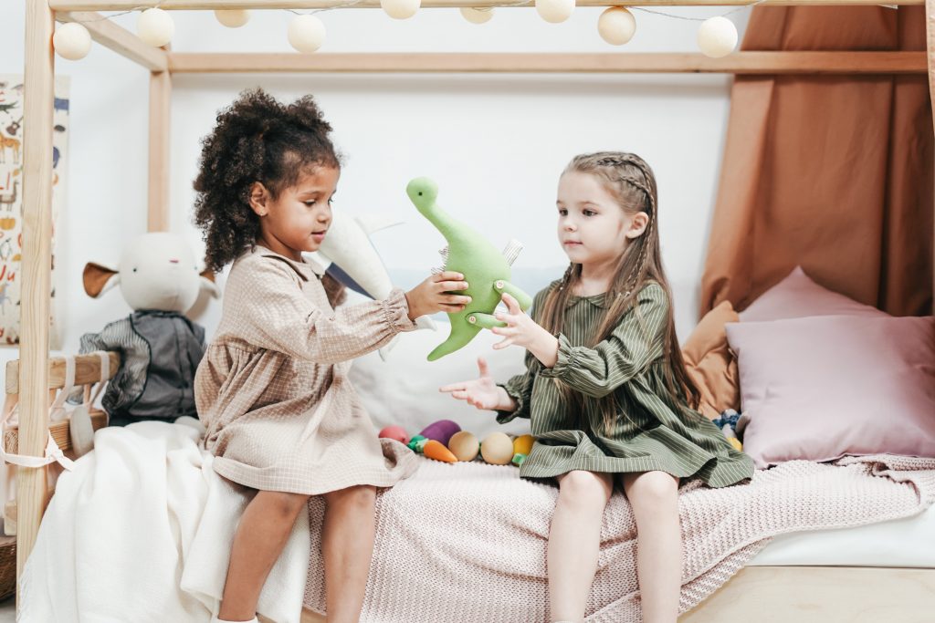 girls sharing toy