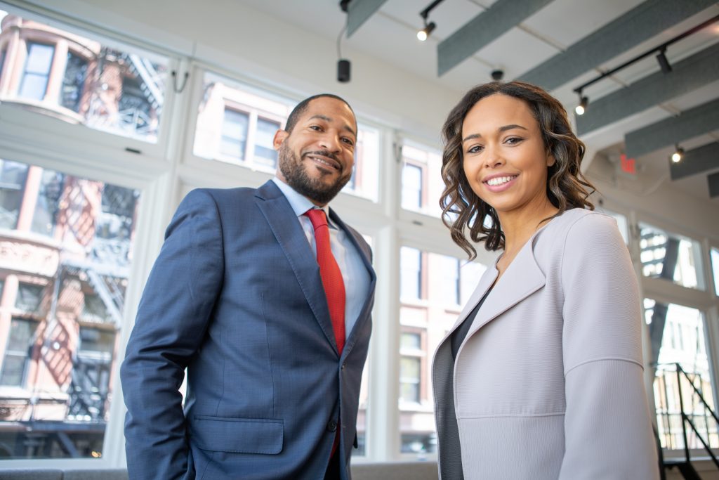 business man and woman standing next to eachother